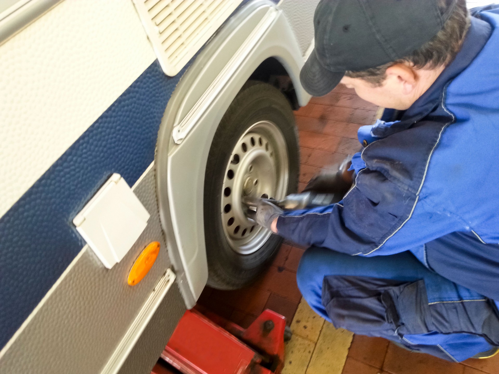 Tire fitter changing a tire on a caravan